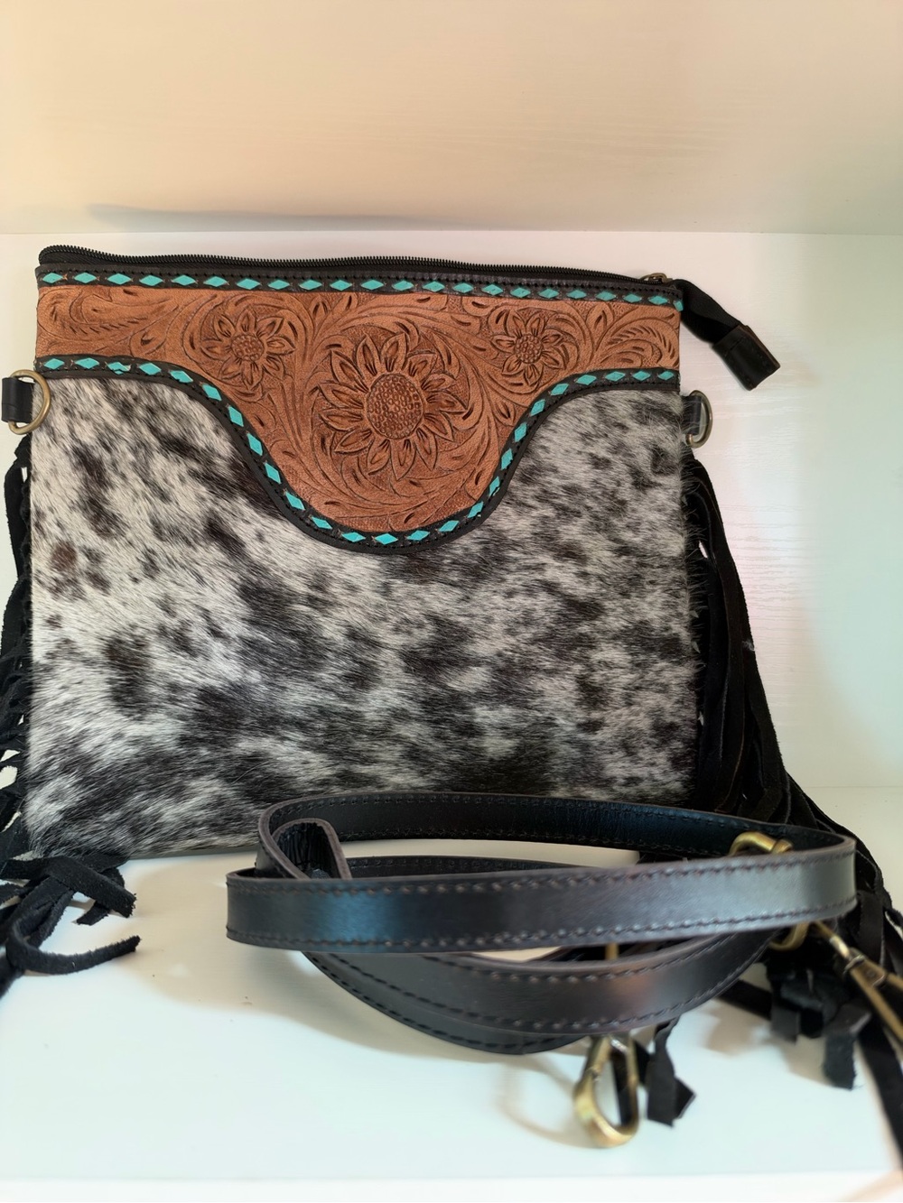 black & white cowhide fringe crossbody bag with tooled leather accents